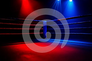 Empty boxing ring with spotlights shining down.
