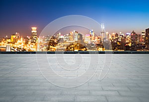 Empty brick floor with dreamlike cityscape