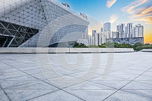 Empty brick road and city buildings skyline