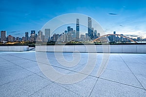 Empty brick road and city buildings skyline