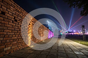 Empty brick wall background, night view, neon light