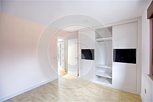 Empty bright bedroom with built-in wardrobes. Interior modern bedroom