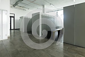 Empty bright locker room and metal bench