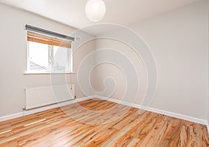 Empty bright room with a wooden flooring