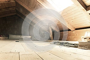 empty brighten attic with light rays at window