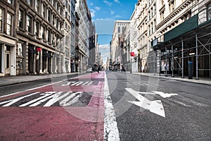 Empty Broadway asphalt street with bus public transport lane in SoHo district in Manhattan, New York City.