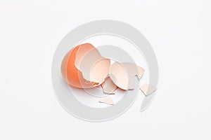 empty broken eggshell of brown egg on white background