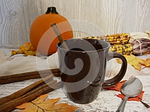 Empty brown cup with fall spices and pumpkin