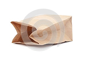Empty brown Kraft paper package isolated on white background. Side view. close-up.