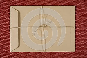 Empty brown old craft paper envelope on textured background with