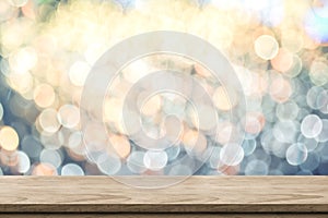 Empty brown wood table top with blur sparkling soft pastel blue and orange bokeh abstract background,panoramic banner for display