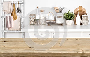 Empty brown wooden table with blurred image of kitchen interior
