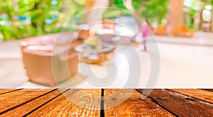 empty brown wooden table and Coffee shop blur background with bokeh image