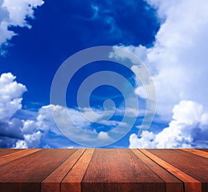 Empty brown wooden table surface and blue sky blurred background image, for product display montage,can be used for montage or dis