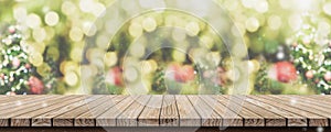 Empty brown wooden table top with abstract green blur christmas