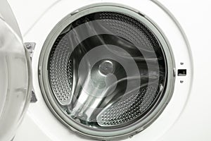 An empty bubbled drum of white washing machine through opend door