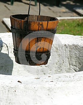 Empty Bucket Hanging Over An Ancient Well