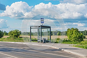 Empty bus stop by the field