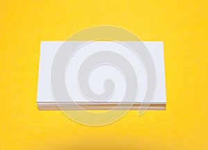 Empty business cards on yellow background