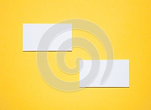 Empty business cards on yellow background