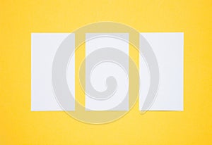 Empty business cards on yellow background