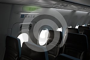 Cabin of a passenger plane with a view of the emergency exit photo