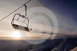 Empty cable car on the background of the sky and mountains