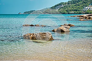 Empty, calm sandy crescent Kalim Bay, Beach with turquoise blue clear water and cirrus cloudy sky