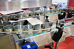 Empty cans on conveyor of food factory