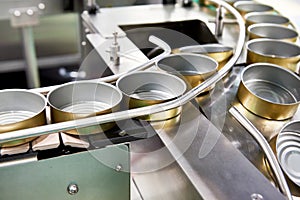 Empty cans on conveyor of food factory