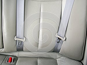 empty car back seat with two gray seat belt or safety belt