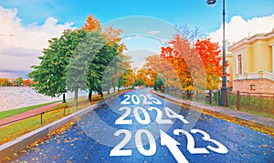 Empty car road drive, arrow sign path view. New year 2023, next goal 2024. Trip way start, travel ahead 2025, end job 20