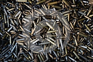 Empty carbine or rifle cartridges. A large number of cases. Background of brass ammunition cartridges to illustrate armed conflict