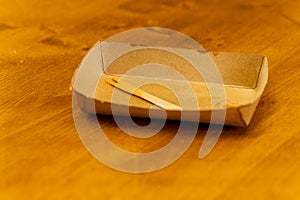 an empty cardboard bowl with a wooden fork