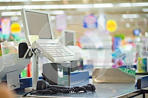 Empty cash desk with computer terminal in supermarket