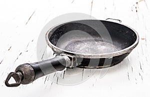 Empty cast iron frying pan on white background