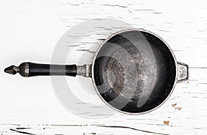 Empty cast iron frying pan on white background