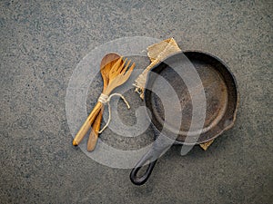 Empty cast iron skillet frying pan flat lay on dark stone background with copy space