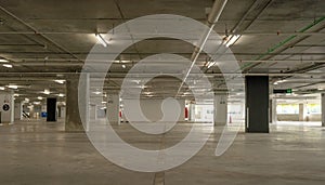 Empty cement Parking Garage interior and exit sign Arrow sign in parking garage interior Industrial building or Supermarket