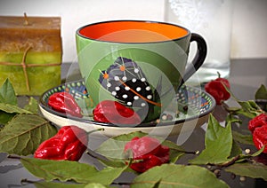 Empty ceramic colourful tea cup with chillies