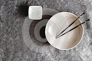 Empty ceramic plate and black chopsticks. Japanese cuisine