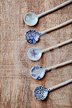 Empty ceramic spoons. Japanese handrafted spoons. Rustic wooden background.