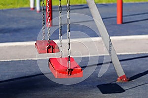 Empty chain swings in children playground