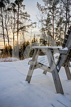 Empty chair covered with snow photo