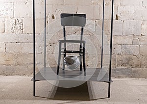 Empty chair and Head by Nino Longobardi in a room of the Castel Del Monte