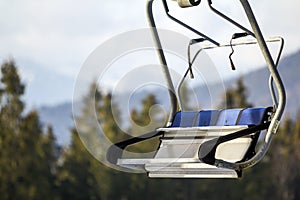 Empty chair lift bench in mountains