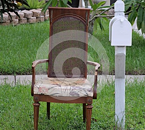 Empty chair next to mailbox in subrurbia