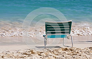 An empty chair on a sandy beach