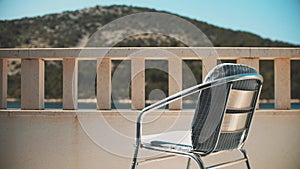 Empty chair on a sea view terrace. Holiday home rental concept
