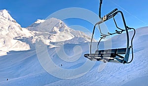 empty chairlift in beautiful snowy mountains in a ski resort